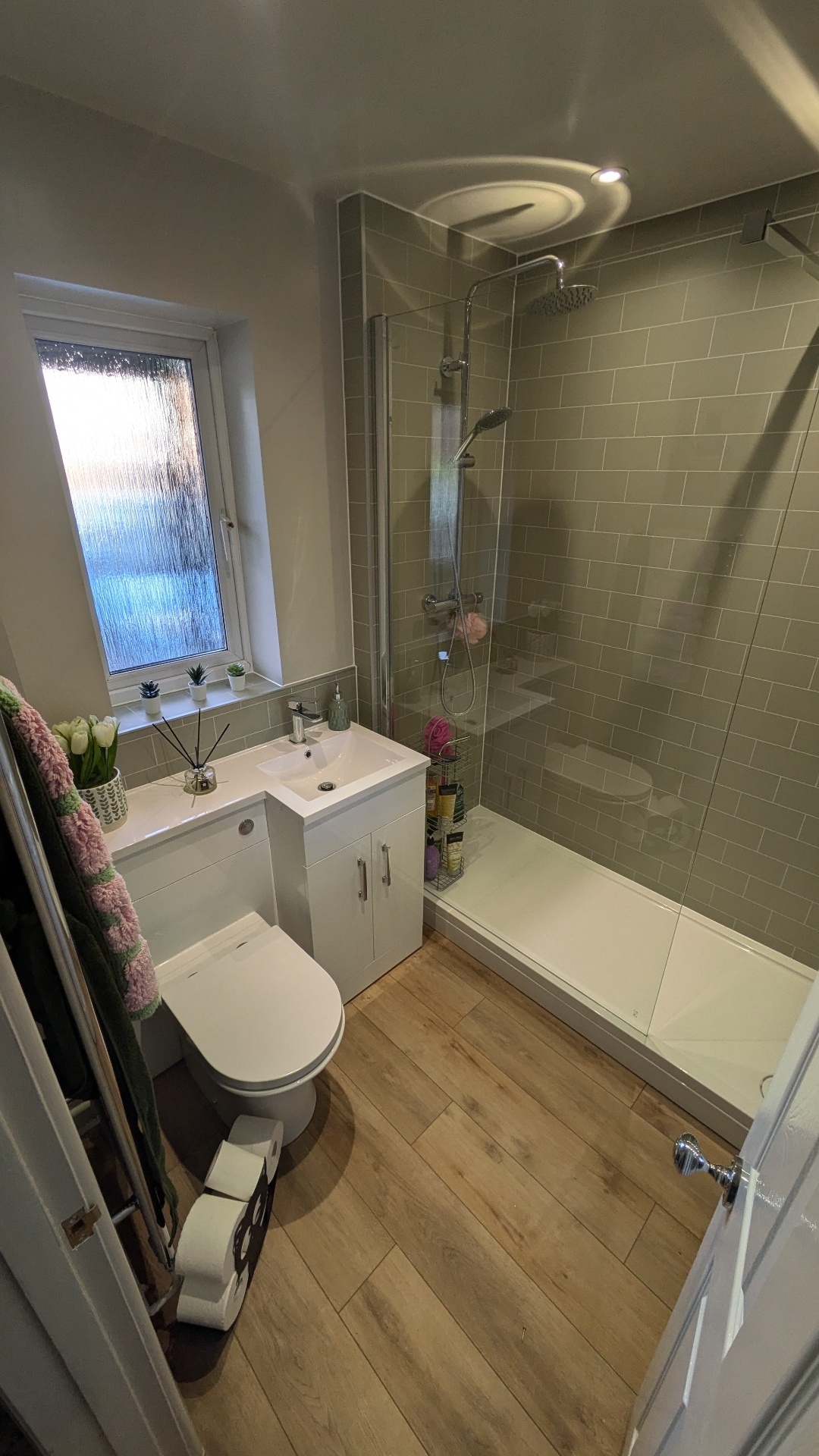 Compact bathroom install with walk-in shower and combined vanity unit