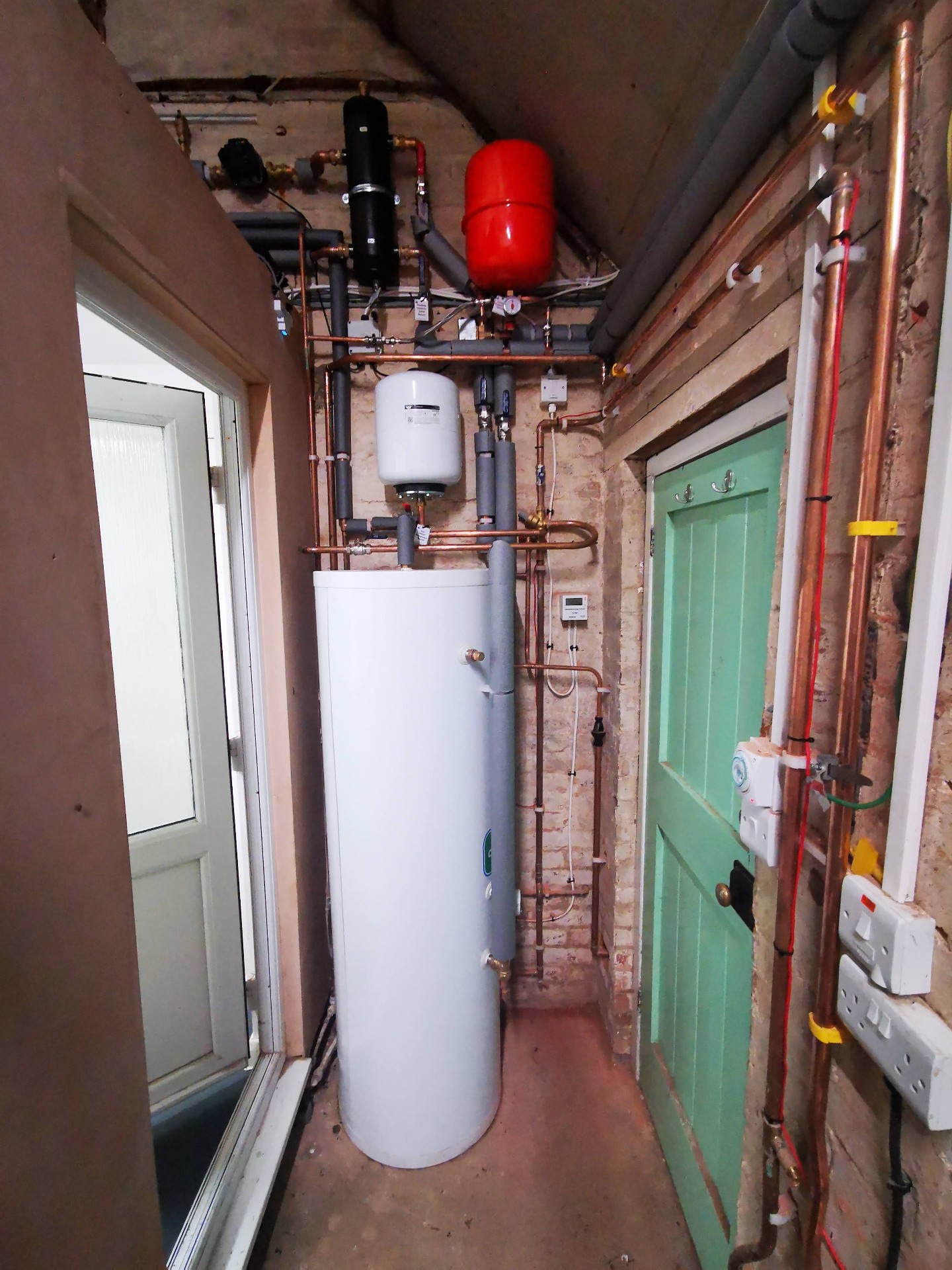 New unvented hot water cylinder installation with copper pipework and isolation valves