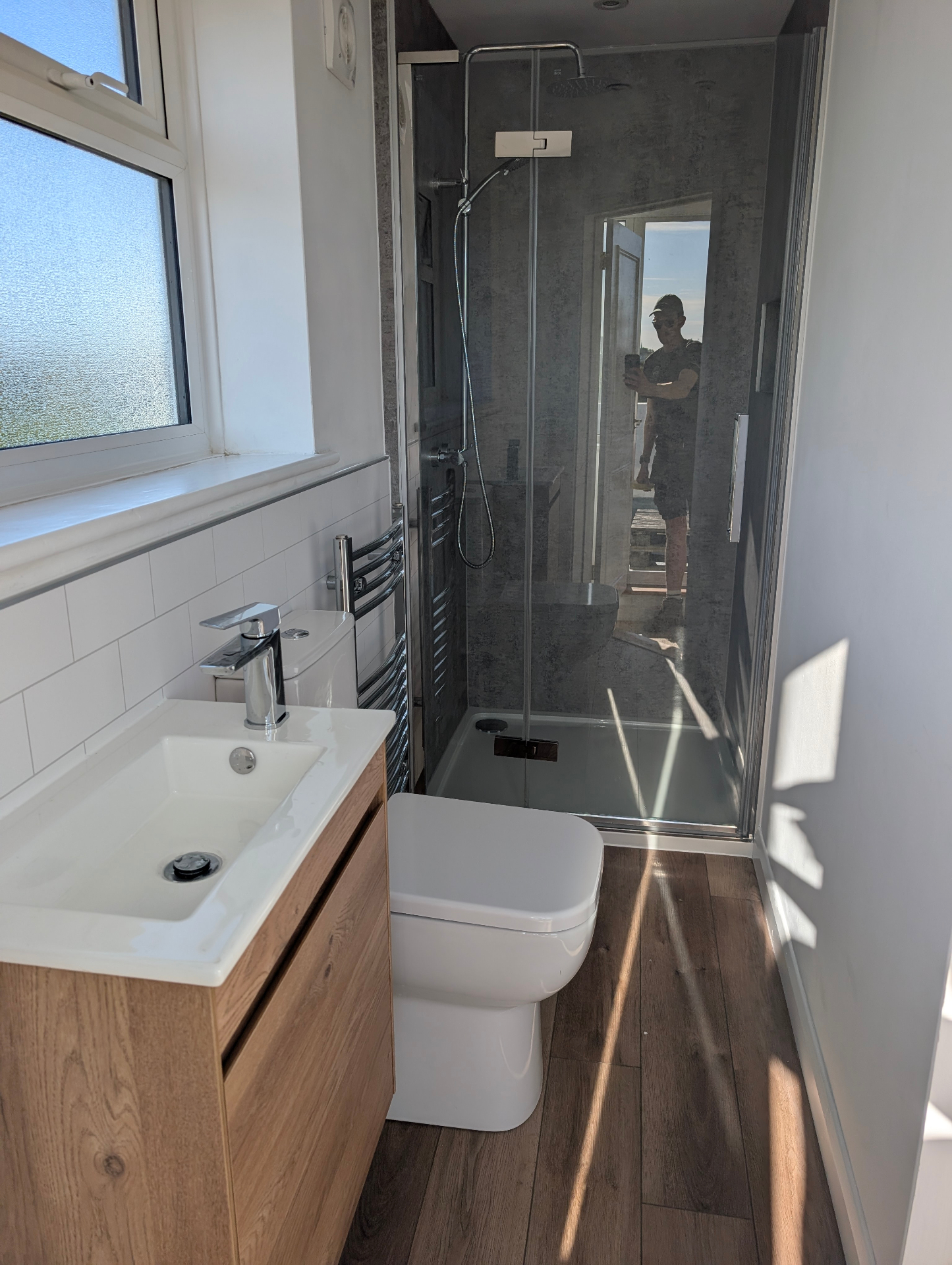 Bathroom with walk-in shower and oak vanity